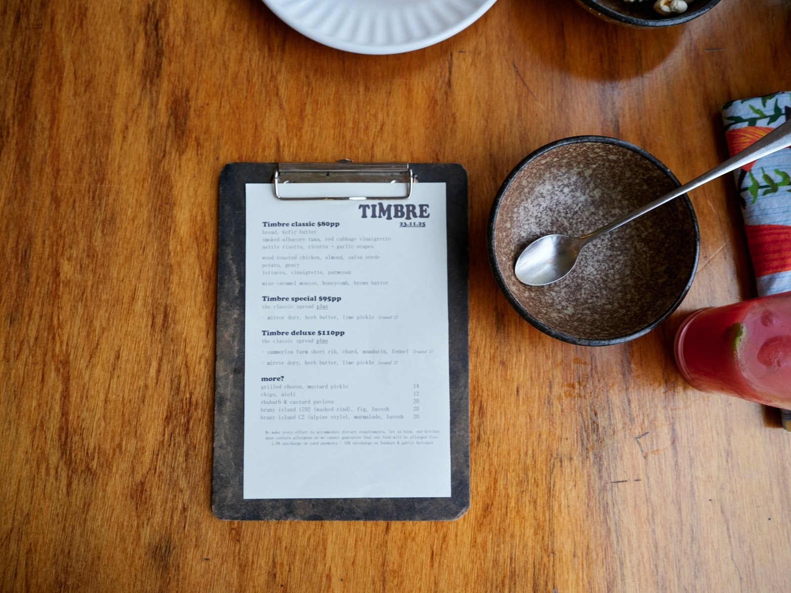Restaurant table set for dining with a menu card and QR code stand