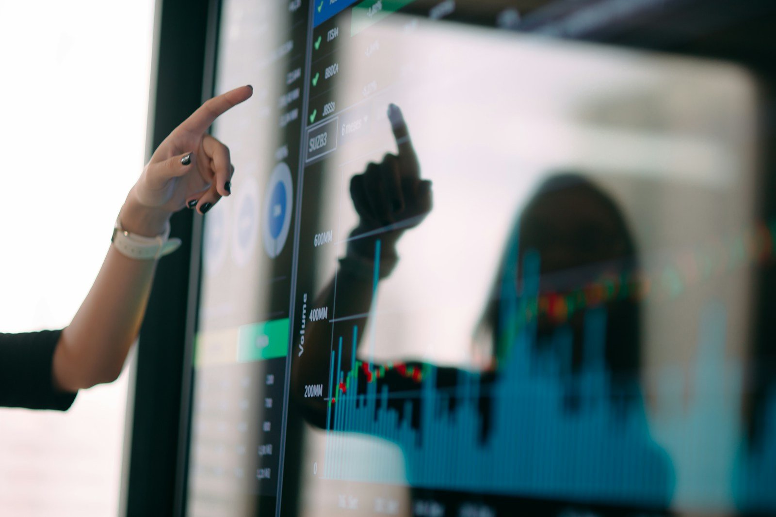 Marketer pointing at scan data on an analytics dashboard monitor