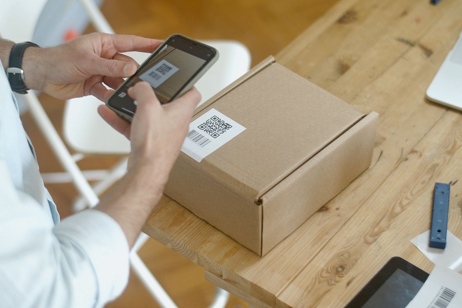 A shopper scanning a QR code printed on a parcel
